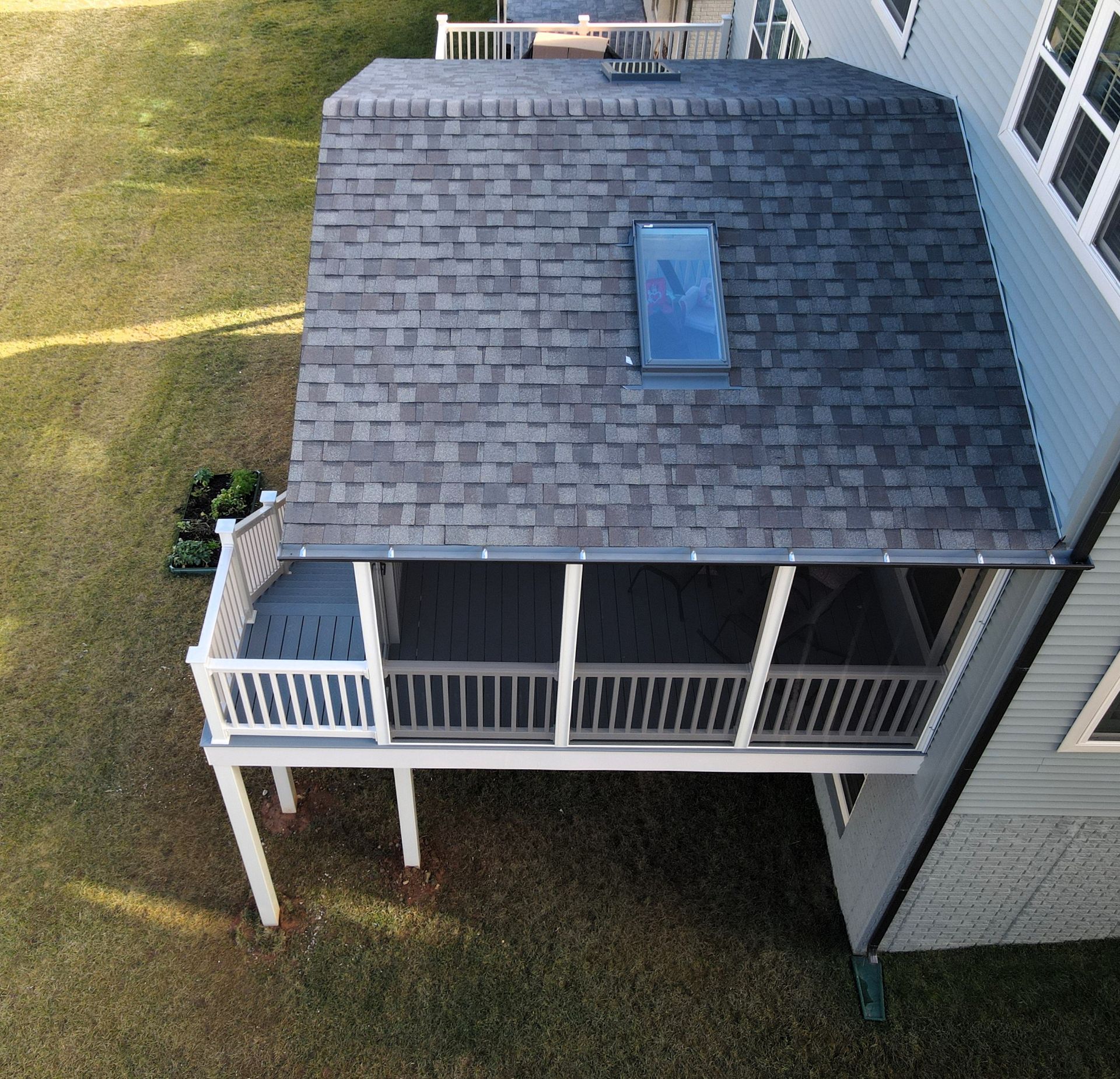an aerial view of a house with a porch and a roof