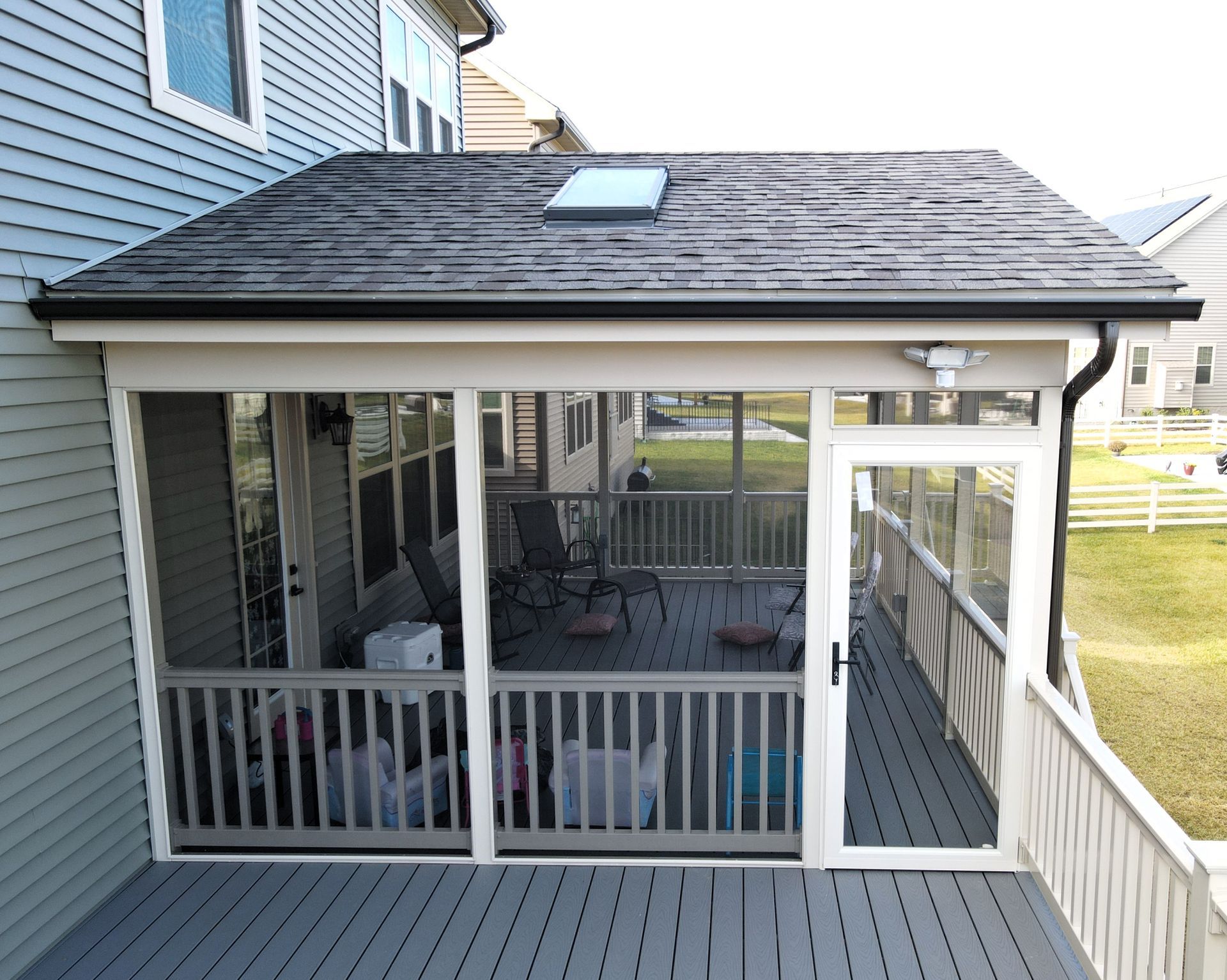 a screened in porch with a skylight on the roof