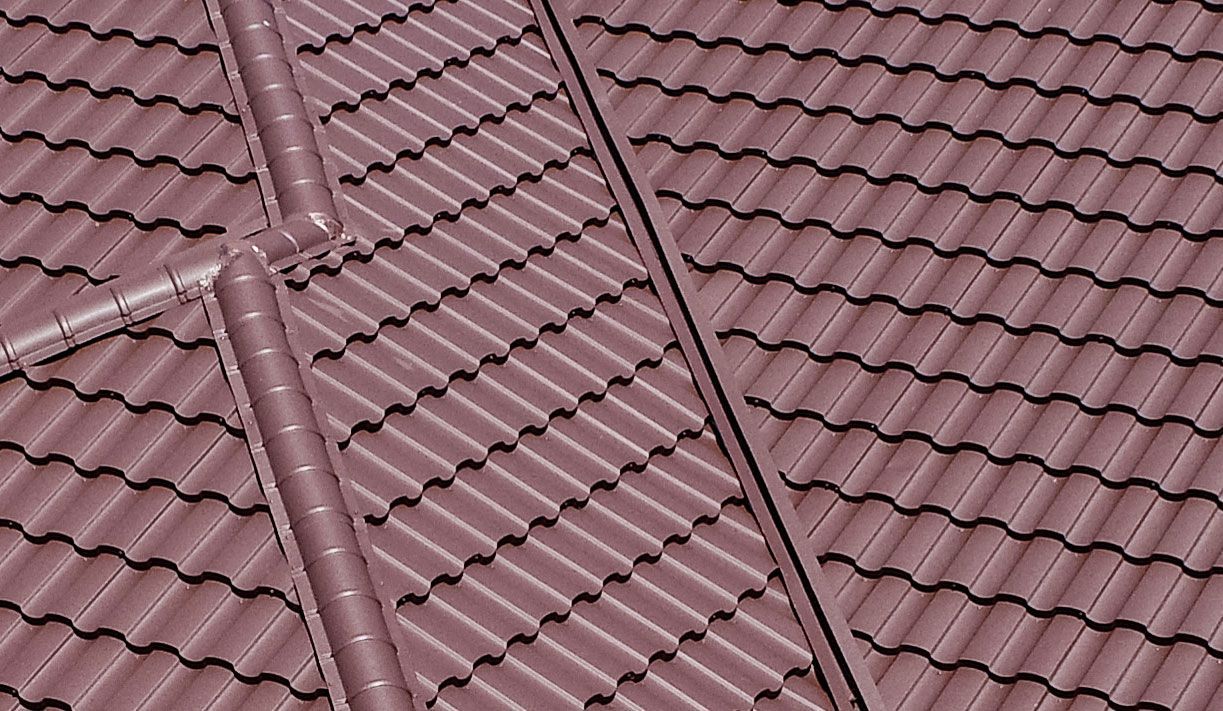 Red tiled roof with diagonal ridges and two dark roof vents.