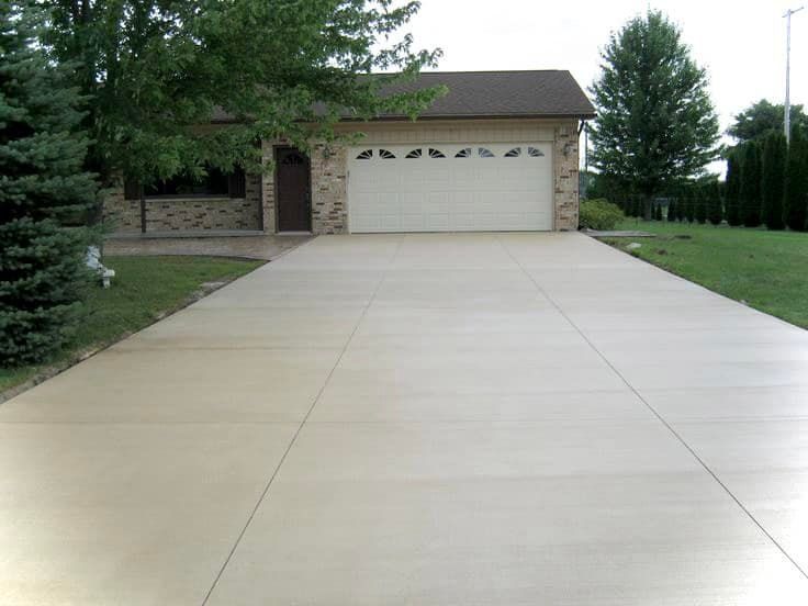 A driveway leading to a garage with a white garage door
