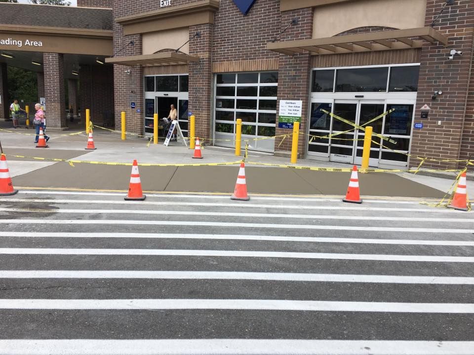 A crosswalk in front of a building with cones on it