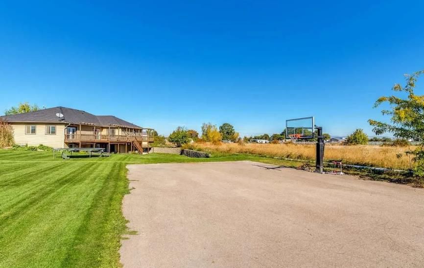 A large house with a basketball hoop in front of it.