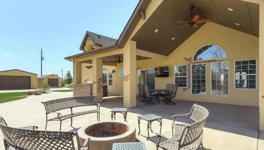 There is a fire pit in the middle of the patio.