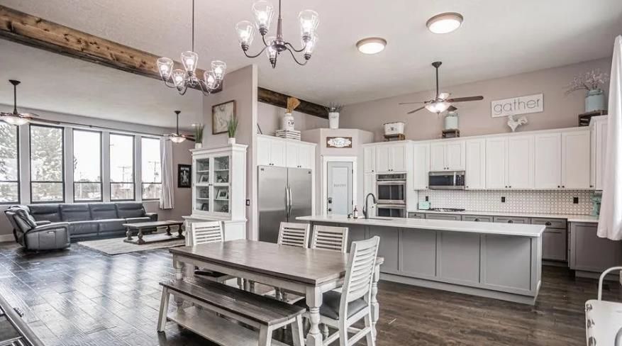 There is a table and chairs in the middle of the room.