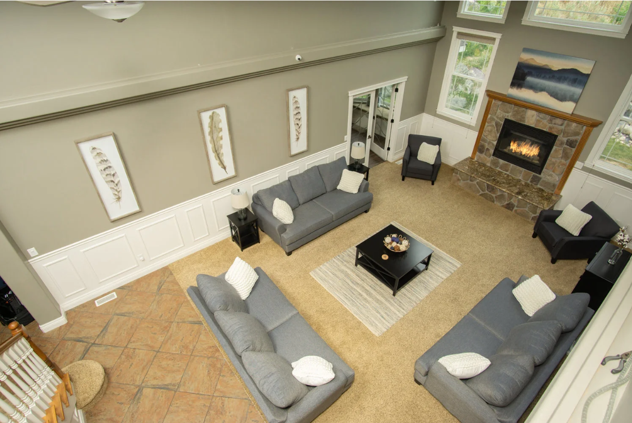An aerial view of a living room filled with furniture and a fireplace