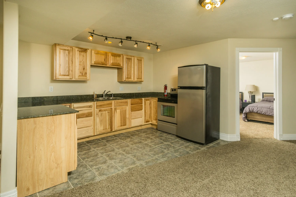 A kitchen with stainless steel appliances and wooden cabinets