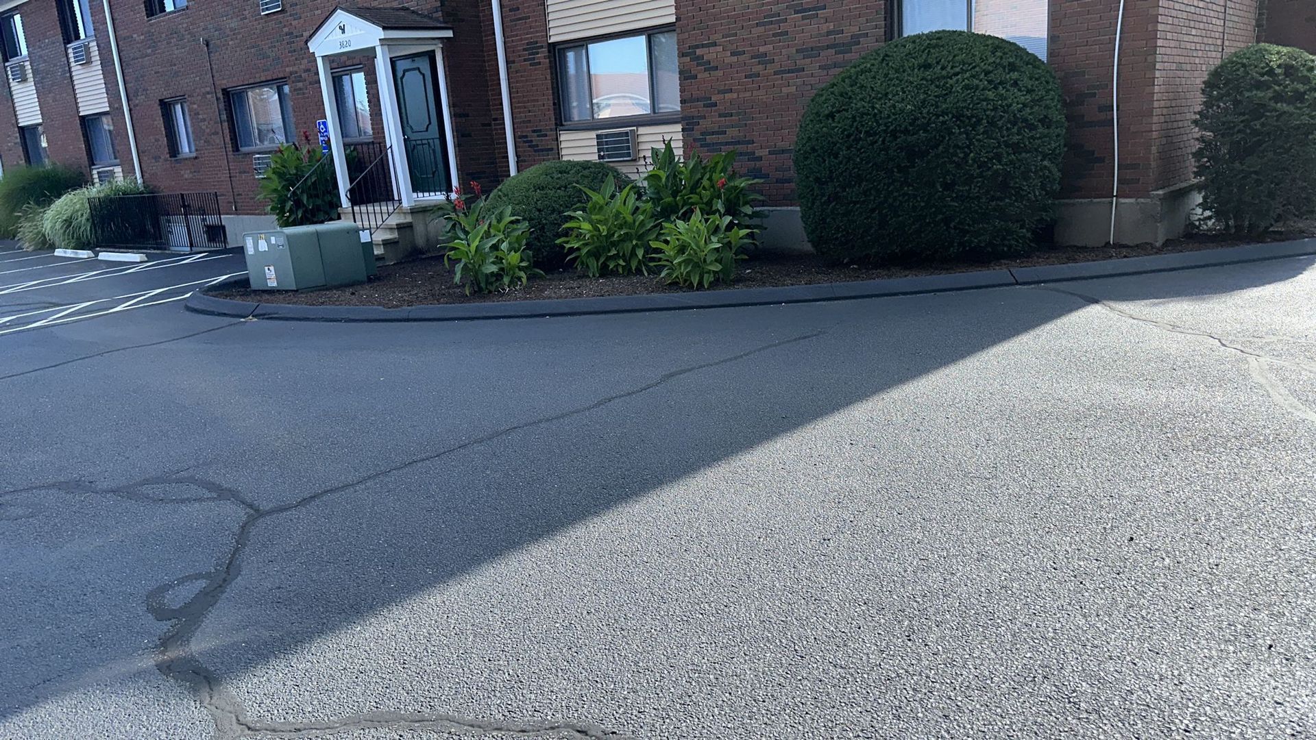 a brick building with a lot of bushes in front of it .