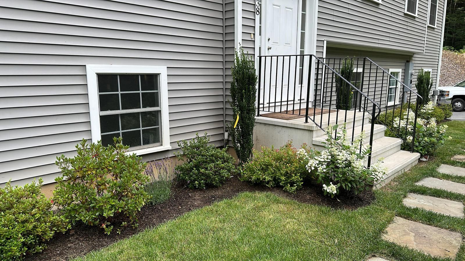 a house with a lush green lawn in front of it .