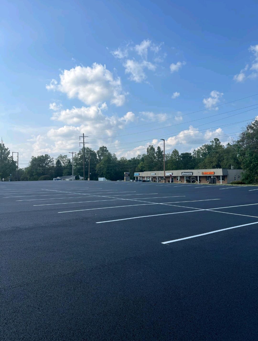 An empty parking lot with a building in the background