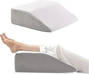 Gray foam leg rest pillow, shown with and without legs resting on it.