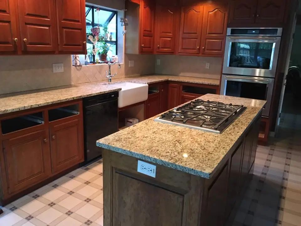 Kitchen with brown cabinets, granite countertops, and stainless steel appliances.