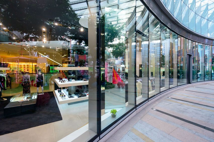 A large glass building with a curved ceiling and a lot of windows.