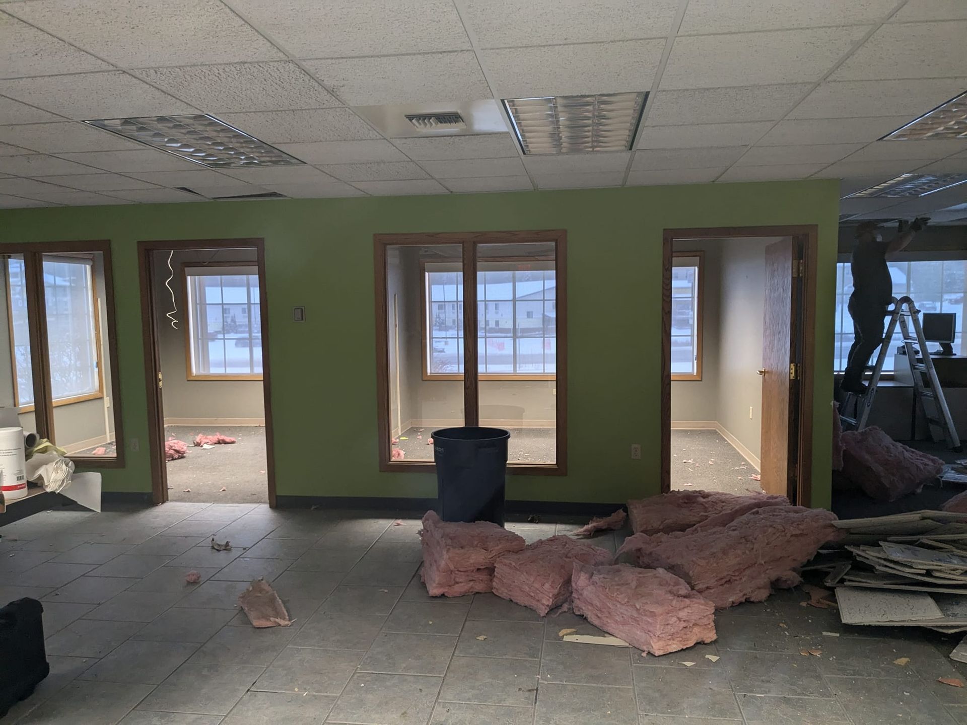 A room with a lot of windows and insulation on the floor