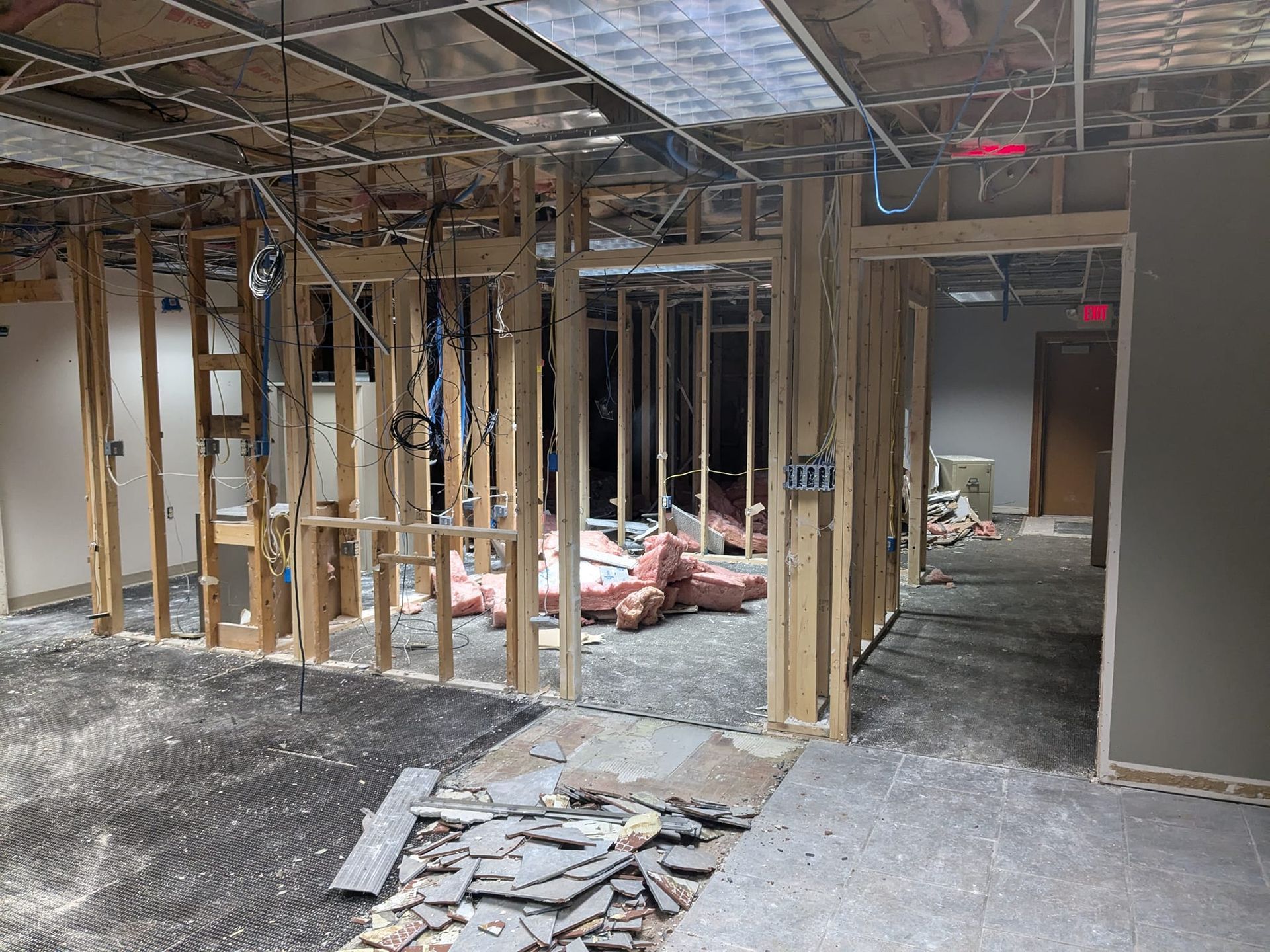 A room under construction with a sign that says exit on it.