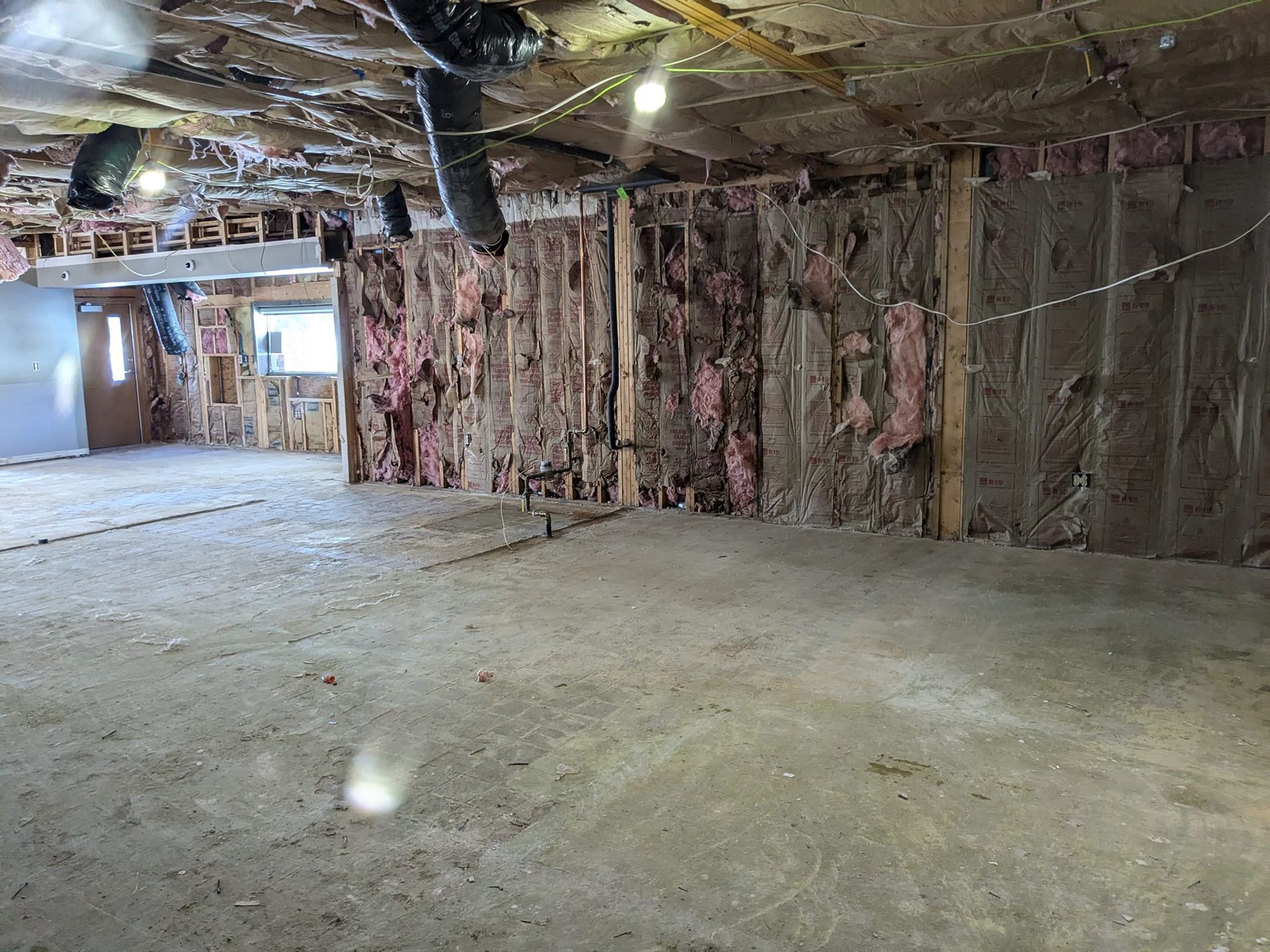 An empty room with a lot of insulation on the walls and ceiling.