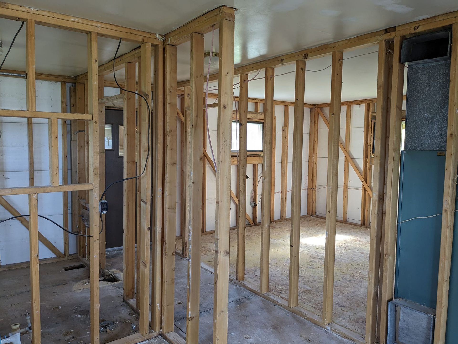 A room with a lot of wooden walls and a door.