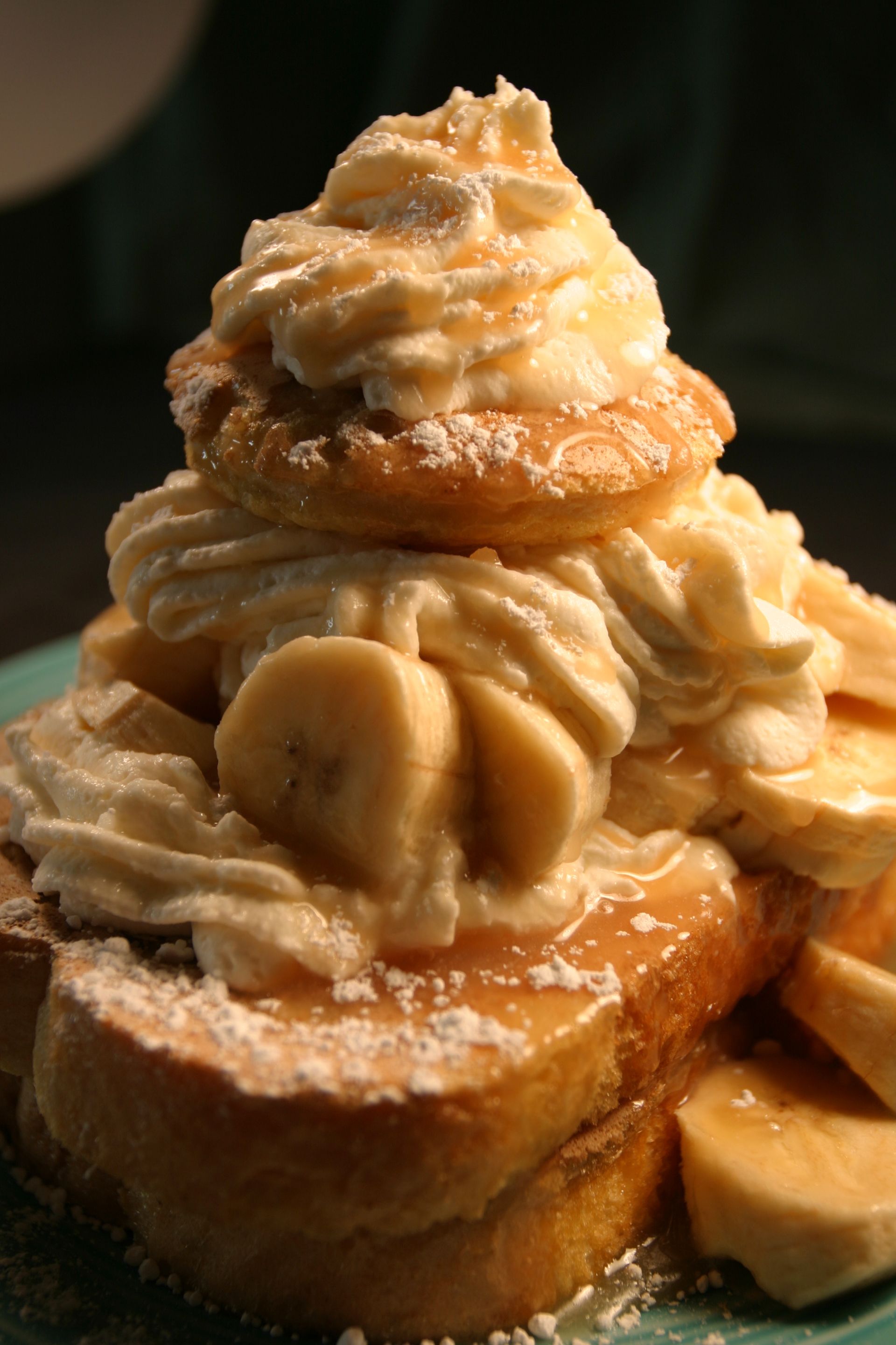 French toast with bananas, whipped cream, and caramel drizzle.