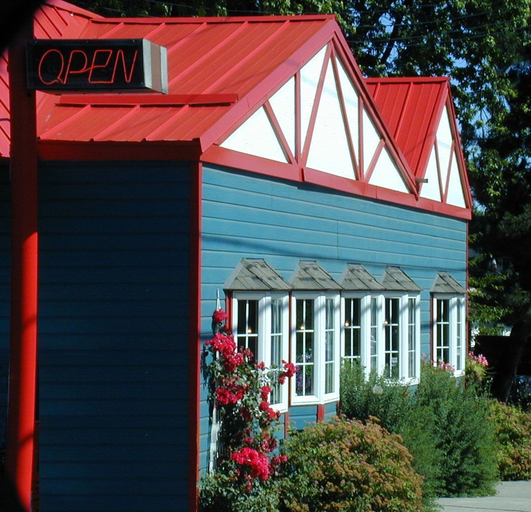 Blue building with a red roof and an 