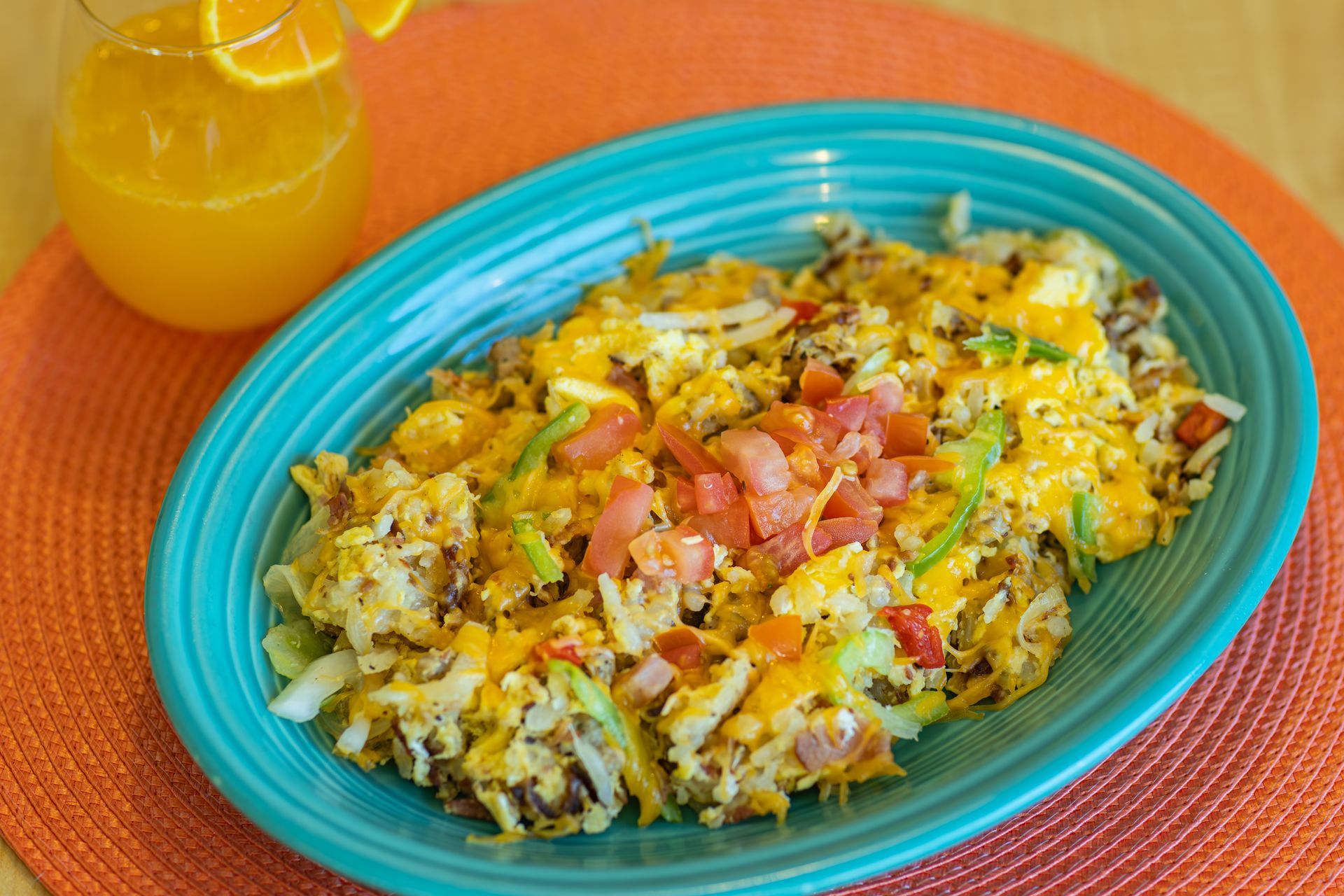 Hash with cheese, tomatoes, and orange juice.