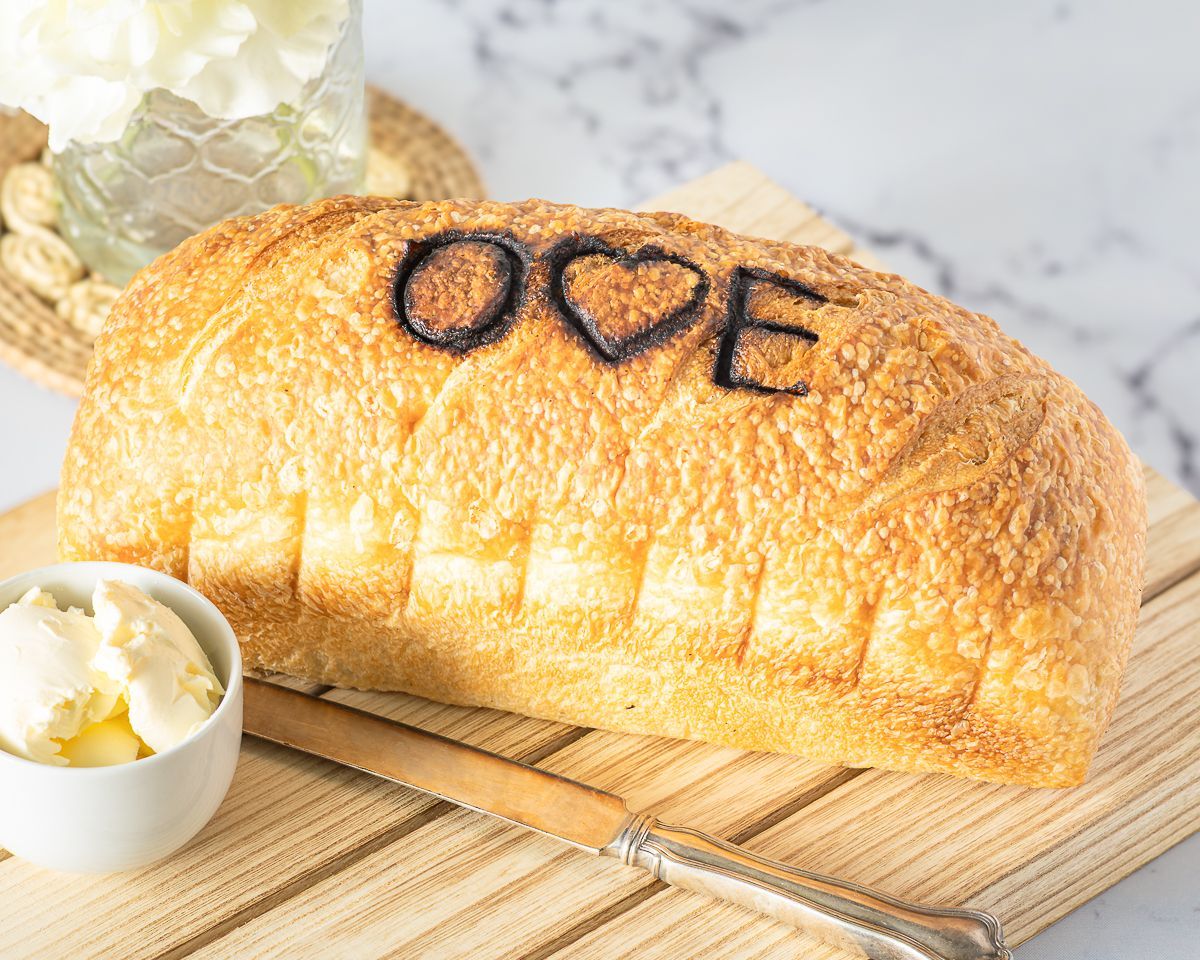 Loaf of bread on wooden board with