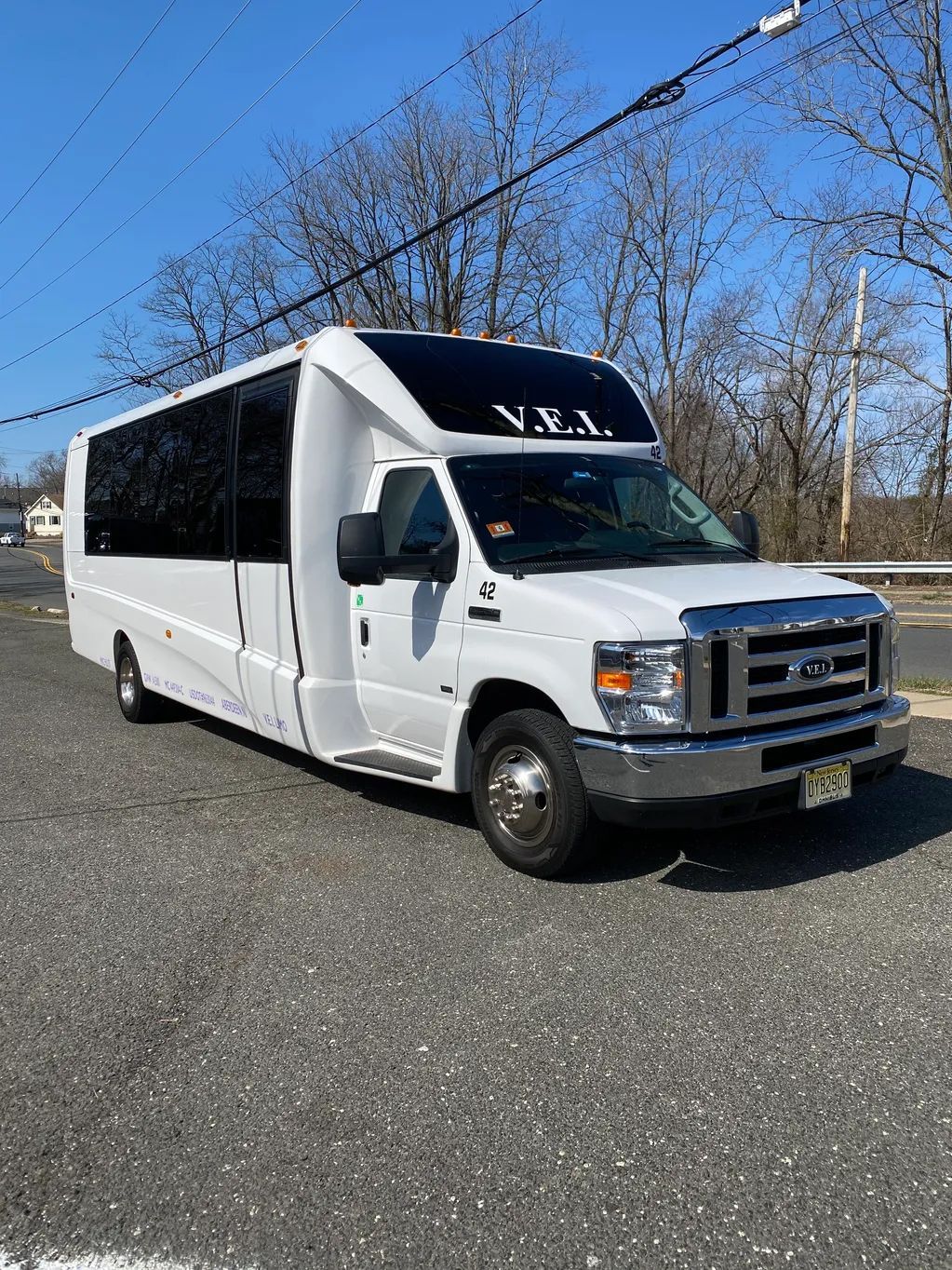 A white bus is parked on the side of the road.