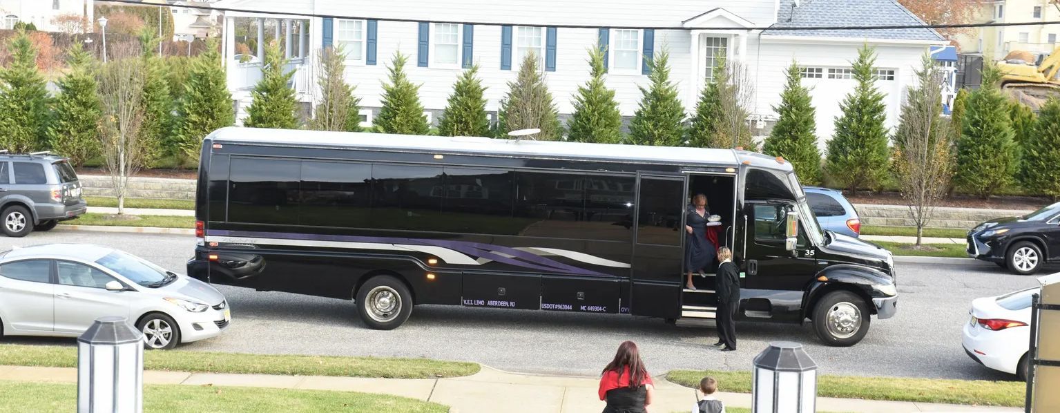 A black bus is parked on the side of the road.