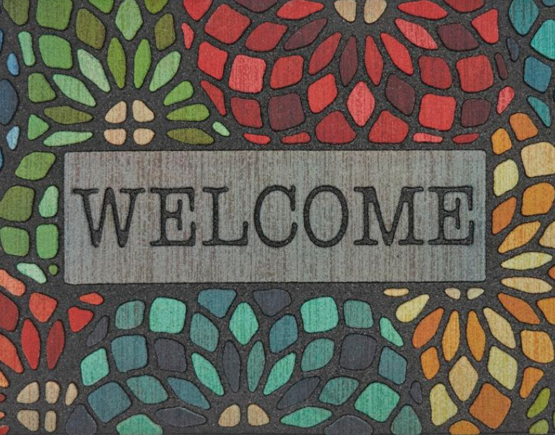 Welcome mat with a mosaic floral design and the word 