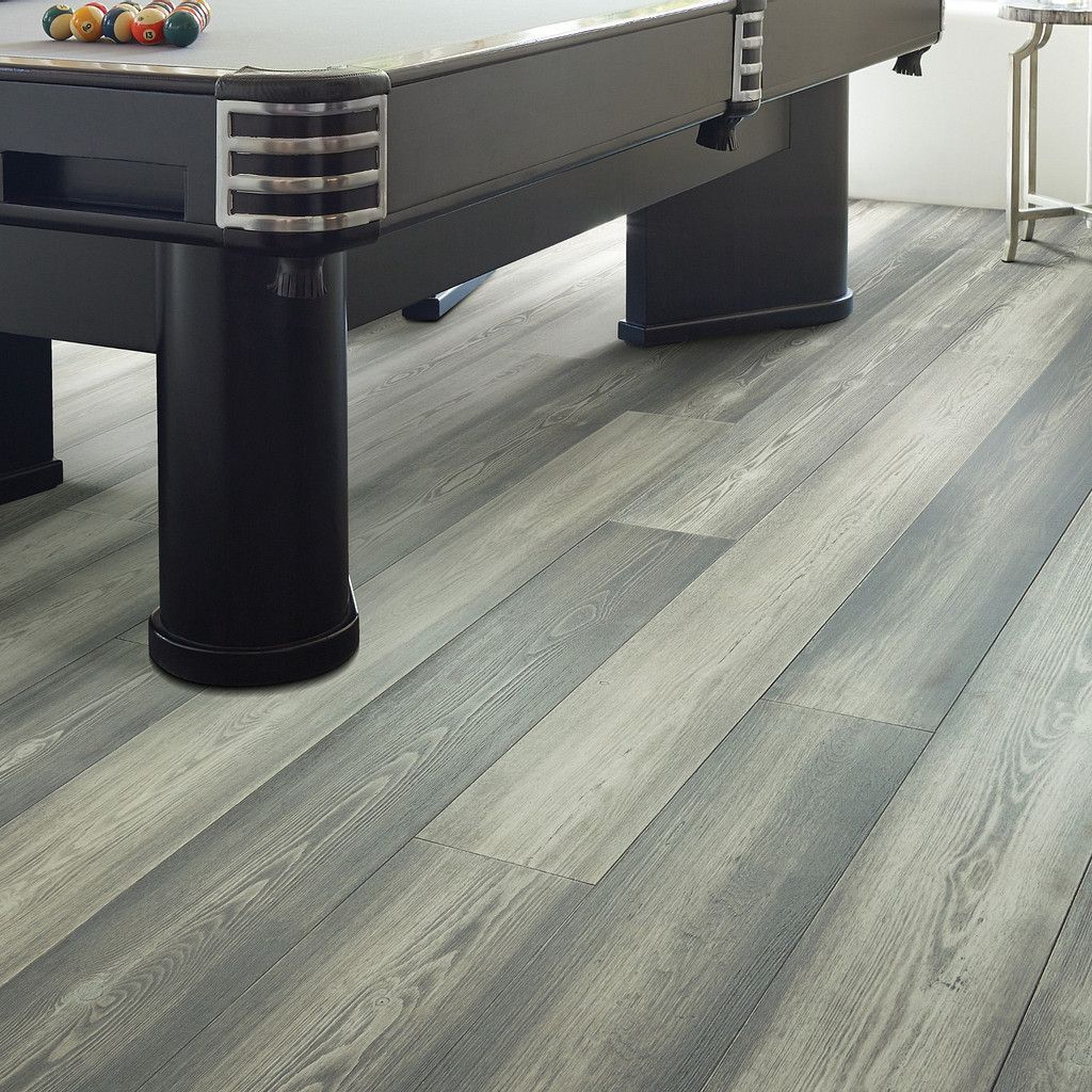 Pool table on grey wood-look flooring. Black legs and table frame.