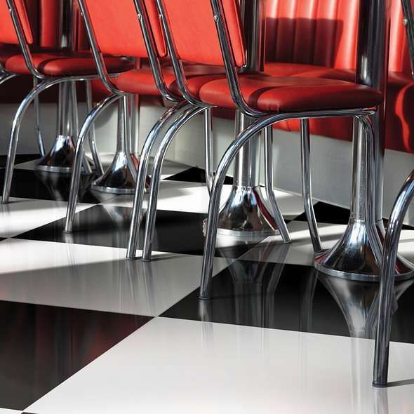Red diner chairs with chrome legs on a black and white checkered floor.