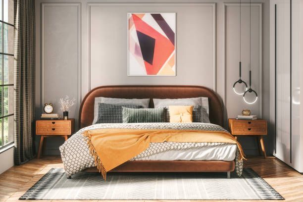 Bedroom with bed, nightstands, abstract art, and large window with curtains.