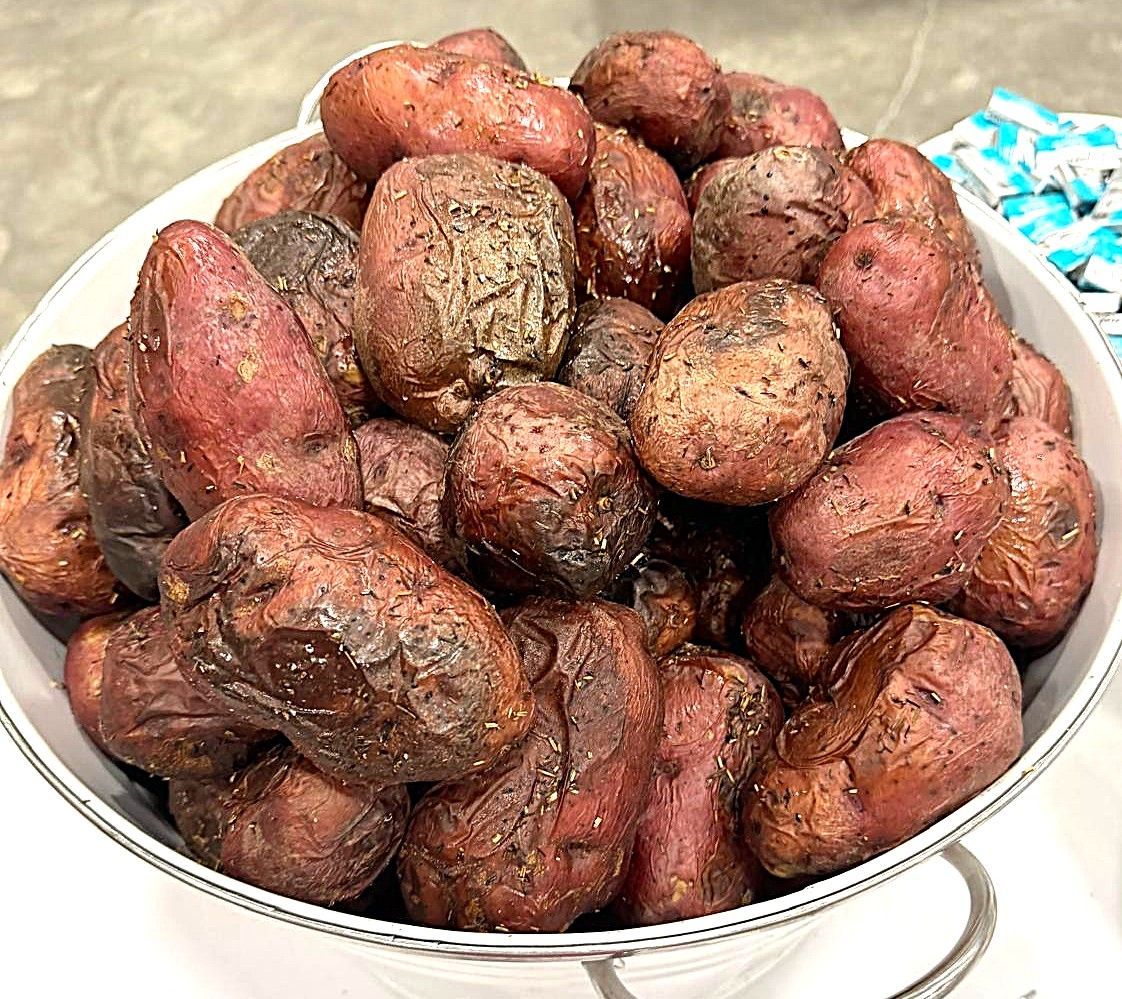 A bowl piled with red-brown potatoes on a countertop