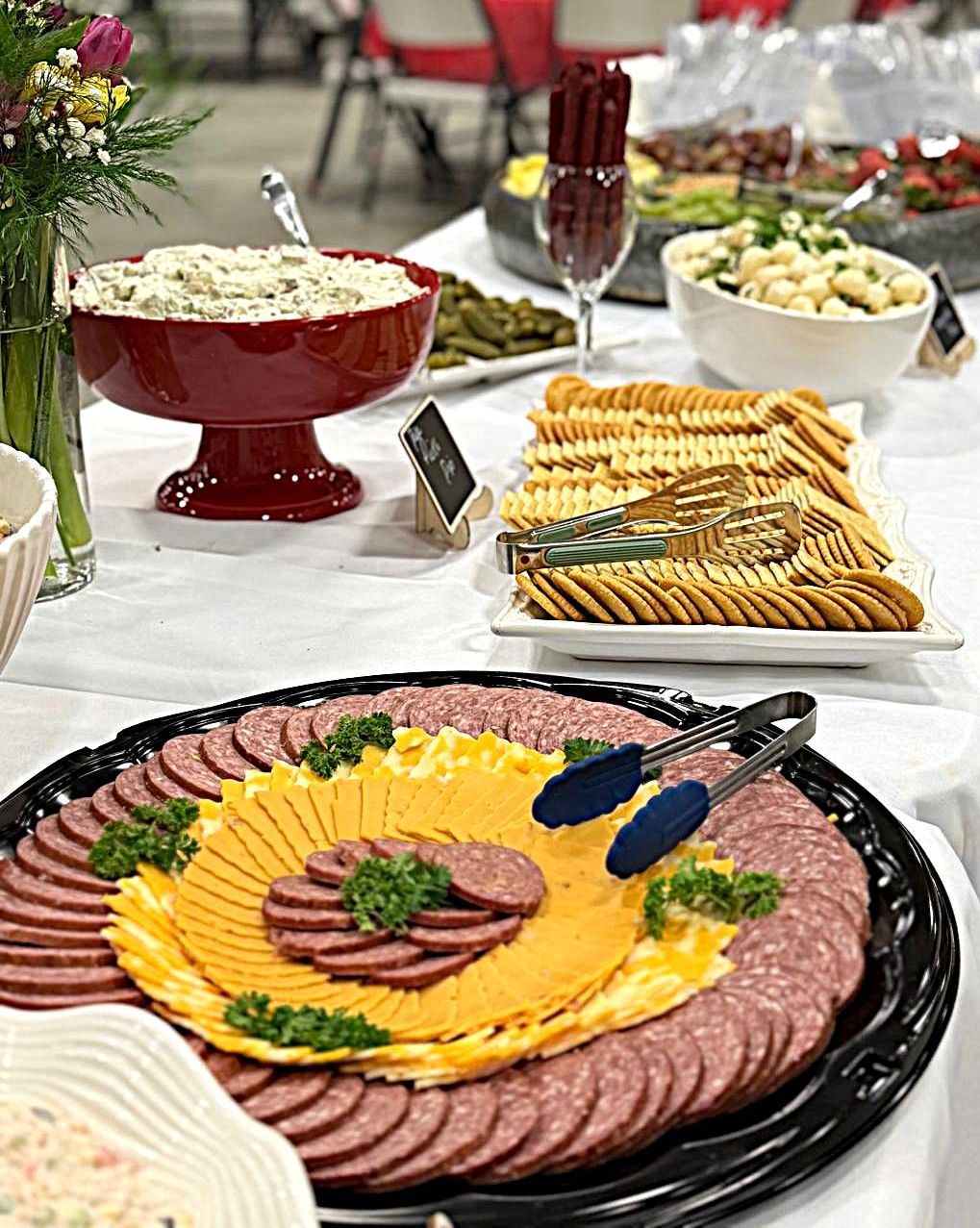 Elegant buffet table with assorted cold platters, salads, and garnished appetizers