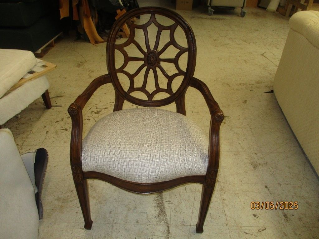 A chair with a spider web design on the back.