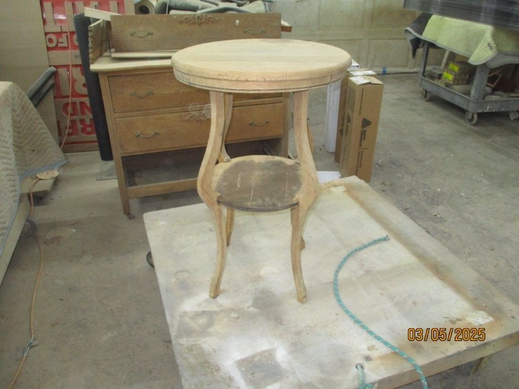 A small wooden table is sitting on top of a wooden table.