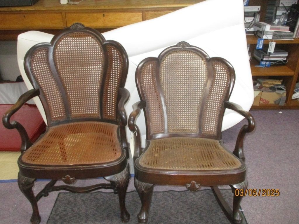 Two chairs with wicker seats are sitting next to each other.