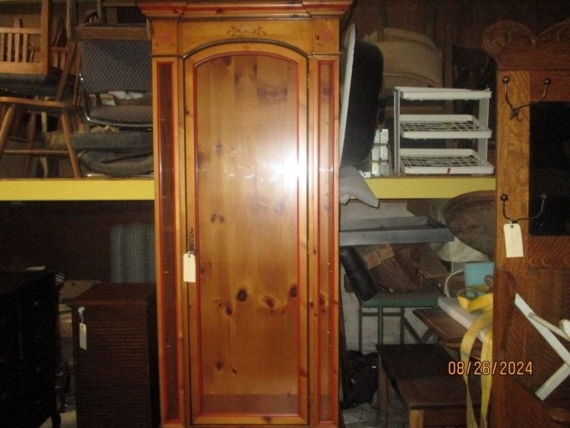 A wooden cabinet with a tag