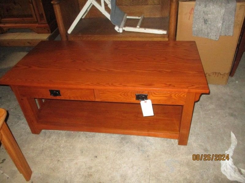 A wooden table with two drawers and a tag on it
