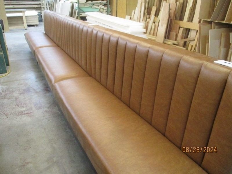 A long brown couch in a room