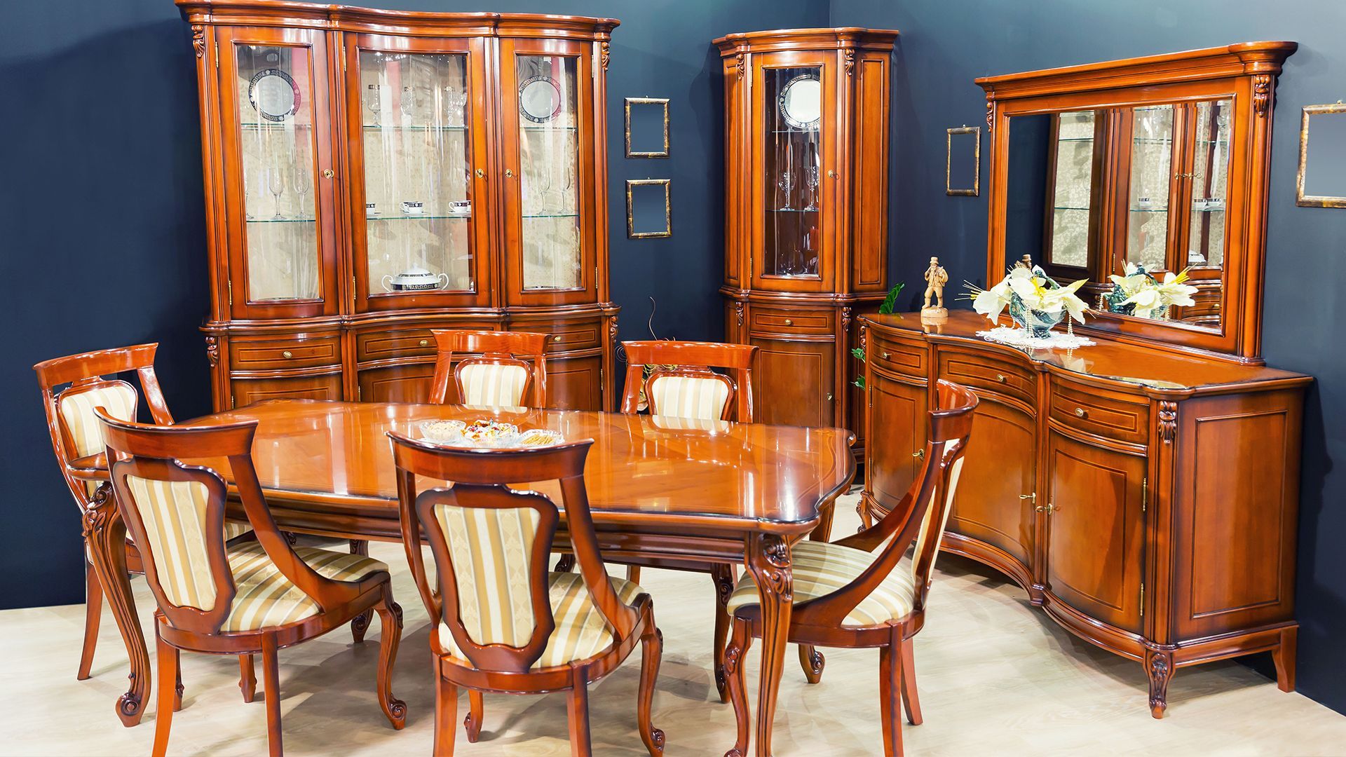 A wooden dining room set with a table and chairs