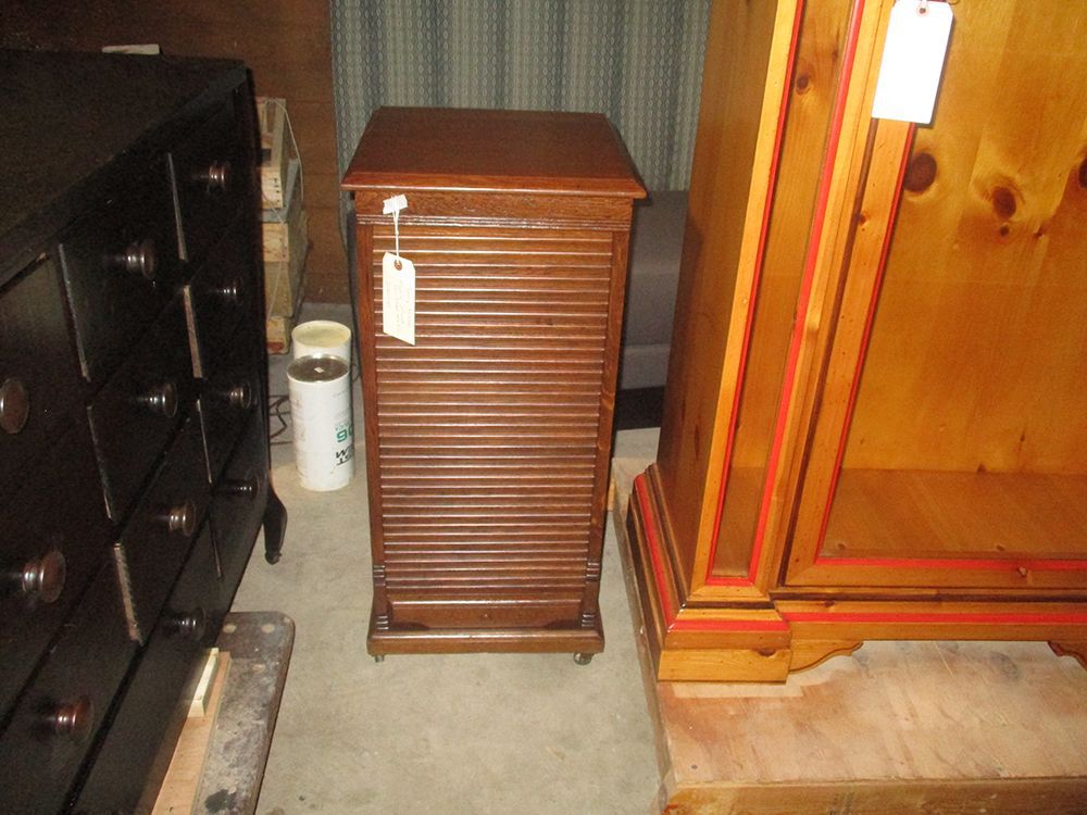 A small wooden cabinet with a tag attached to it