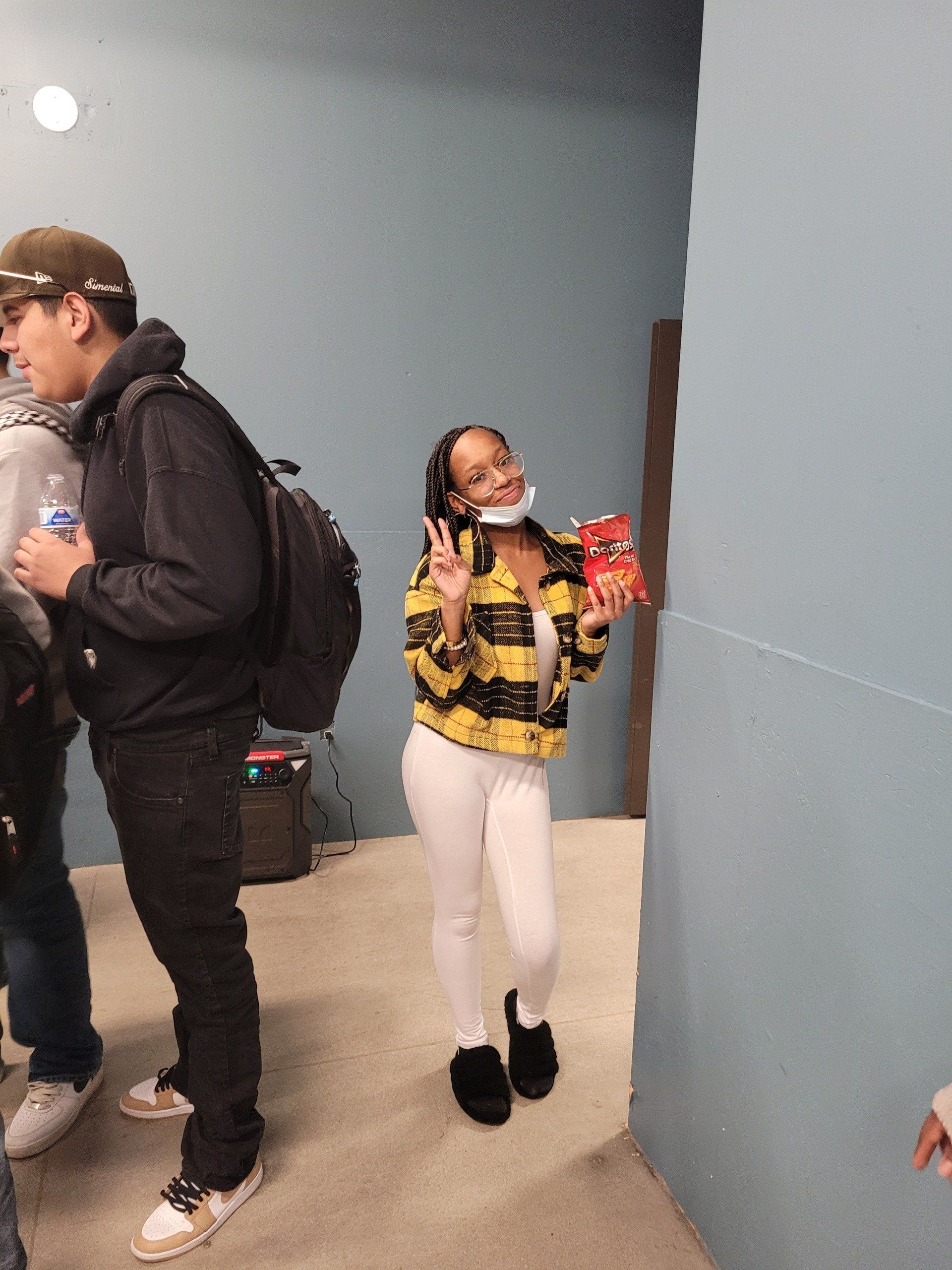 A man and a woman are standing in a hallway.