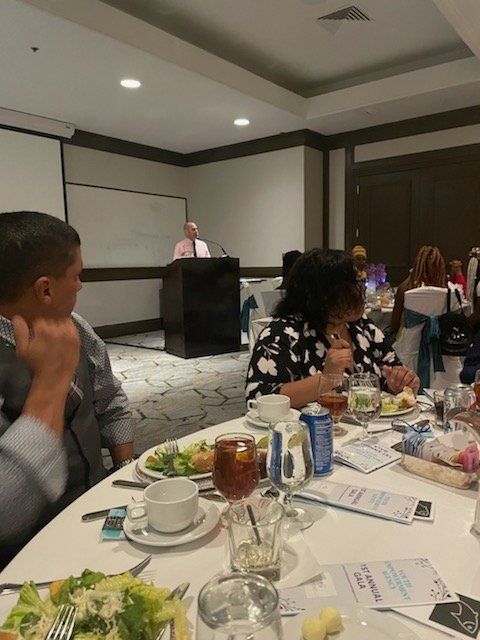 A group of people are sitting at a table with plates of food