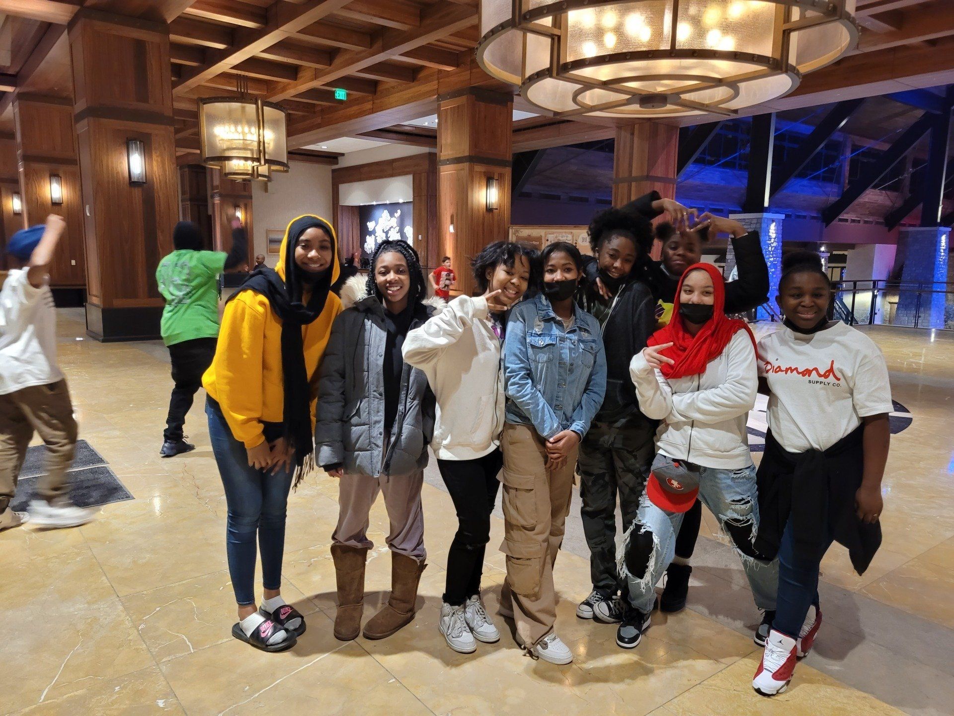 A group of people are posing for a picture in a room.