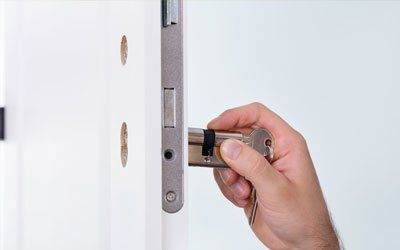 Hand Installing Door Lock At Home