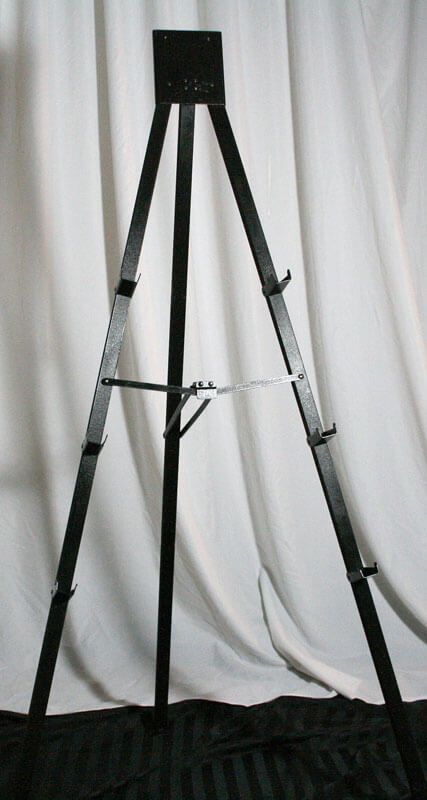 Black metal easel against a white backdrop.