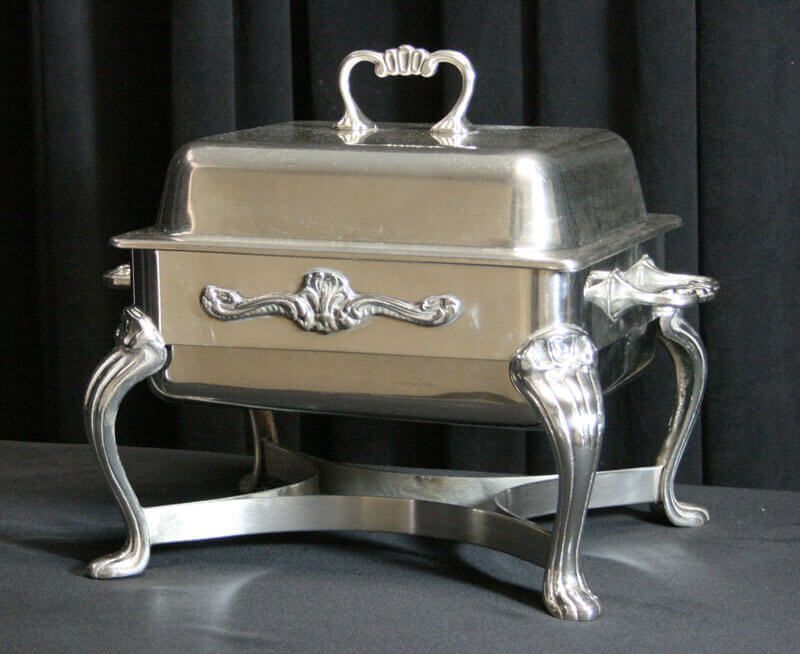 Silver rectangular chafing dish with decorative handles and legs.