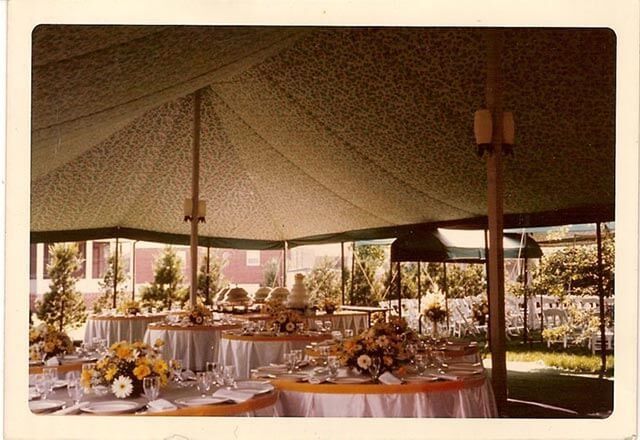 The inside of a tent with tables set up for a party