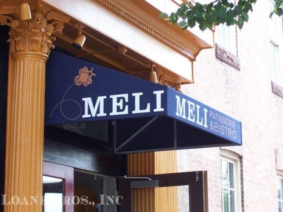A blue awning with the word meli on it