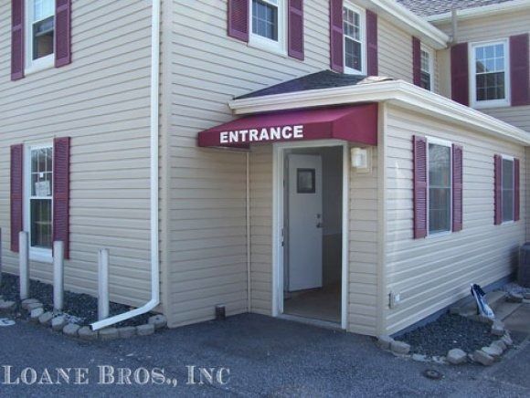 A house with a red awning that says entrance