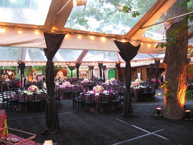A large tent with tables and chairs underneath it